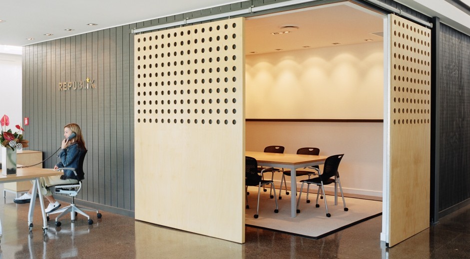 Human-Centered Interior Design: A Guide to Empathetic Spaces 2 Republik office in Auckland with a perforated timber sliding wall opening to a meeting room