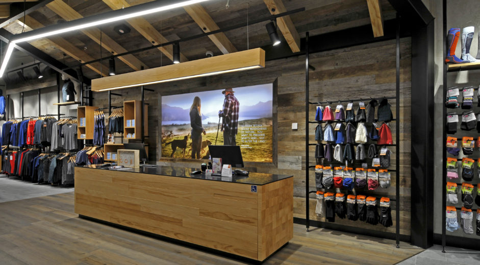 Human-Centered Interior Design: A Guide to Empathetic Spaces 1 Icebreaker store at Auckland International Airport with timber counter, barn wood walls and natural materials