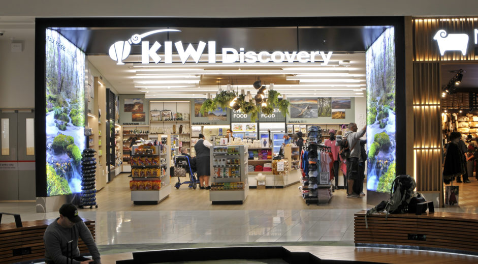 Retail Store Design Ideas That Boost Sales and Brand Identity 2 Kiwi Discovery souvenir shop at Auckland International Airport with white and timber joinery and hanging plants