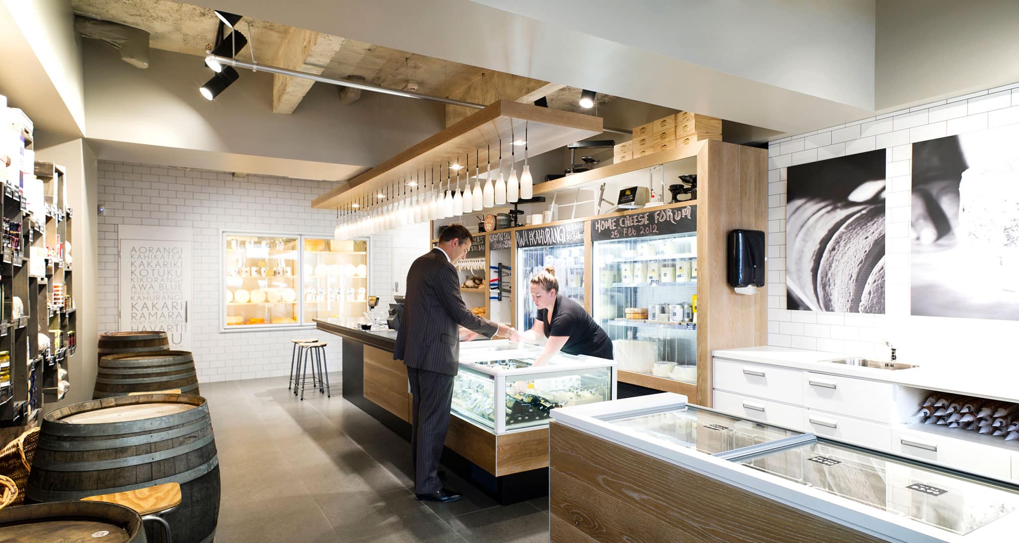 Kapiti concept store with exposed brick, white tiles and timber barrels