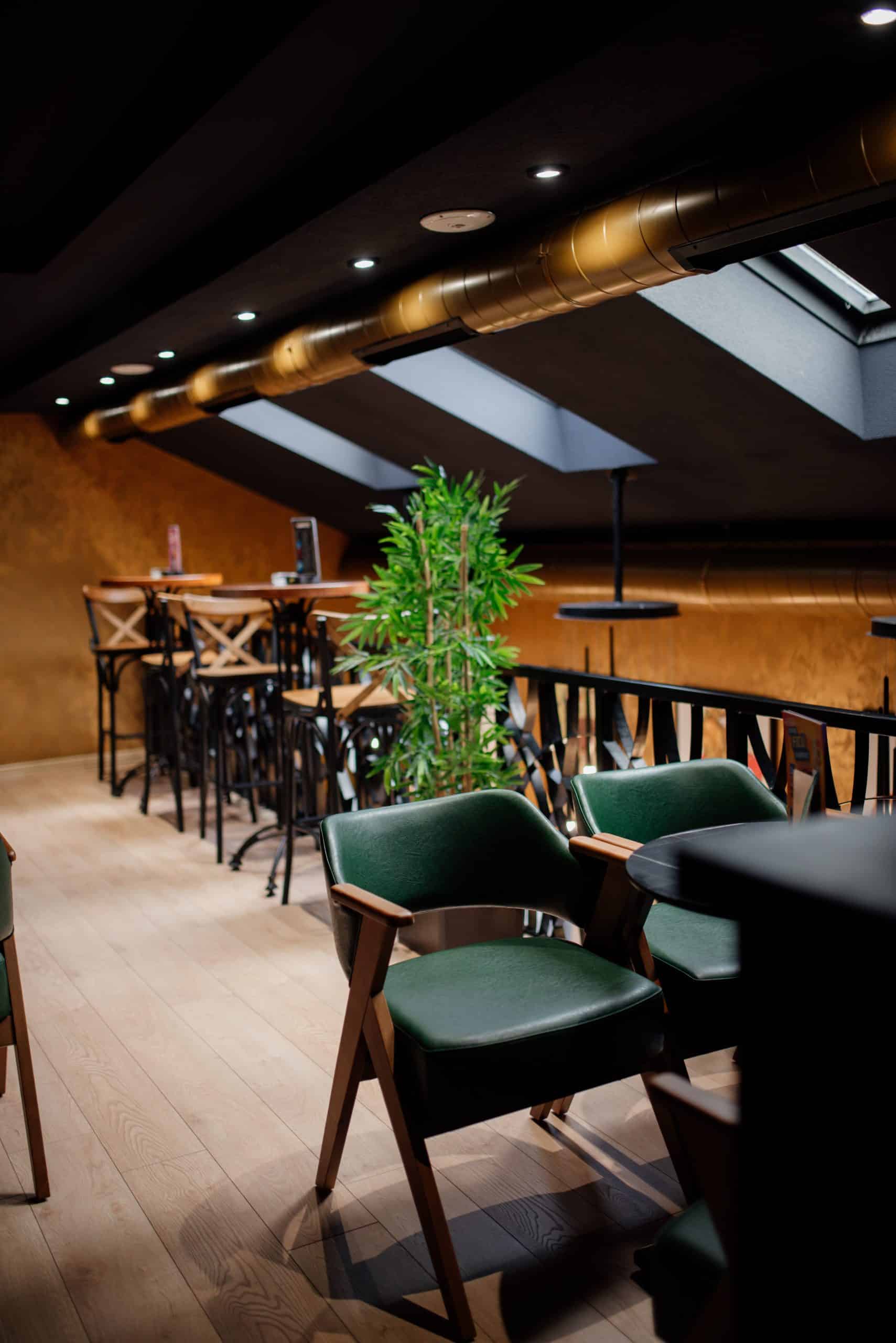 Industrial-style cafe interior with bar stools and lounge chairs illustrating a thoughtful seating layout