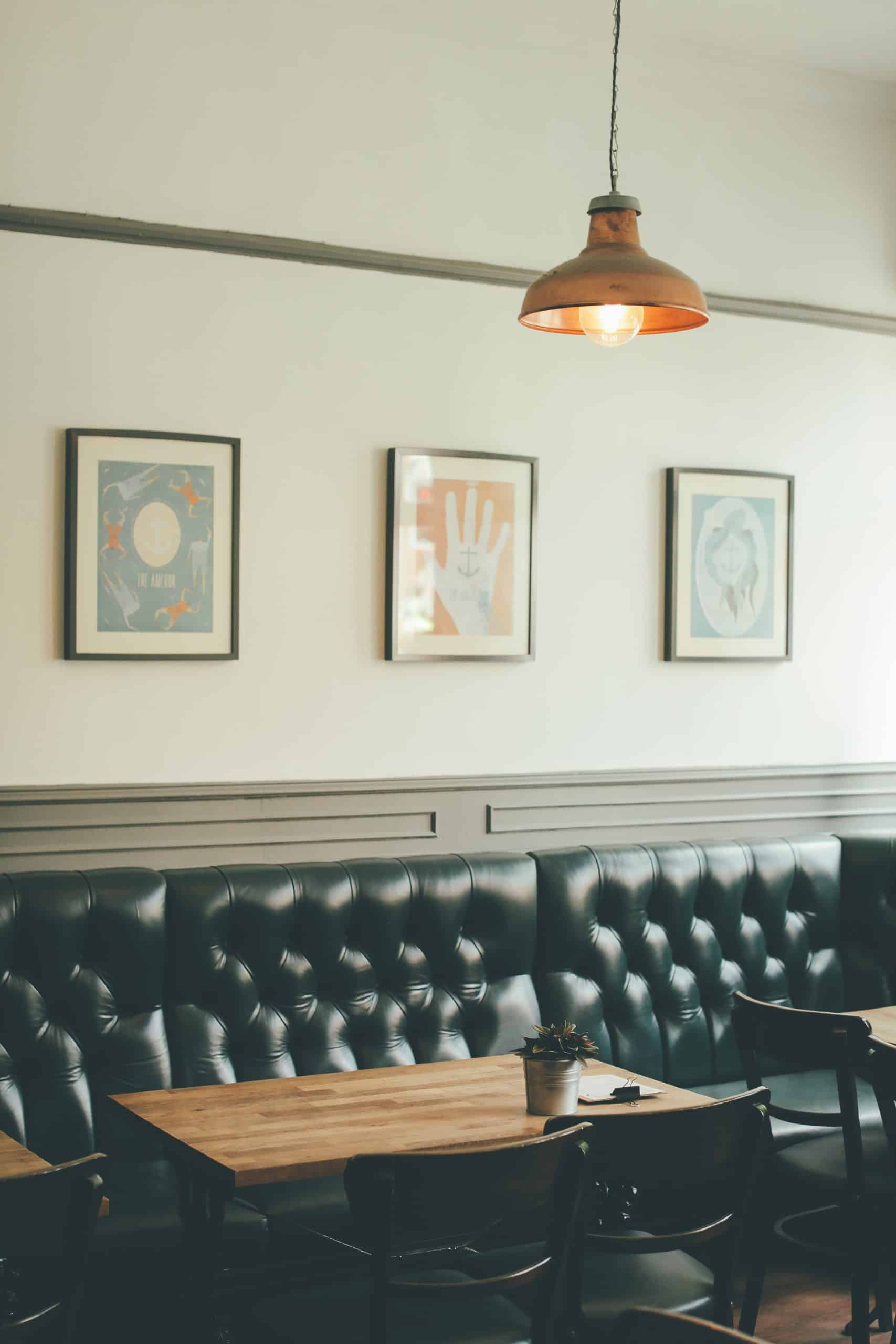Leather booth seating along a cafe wall, an example of banquette-style seating