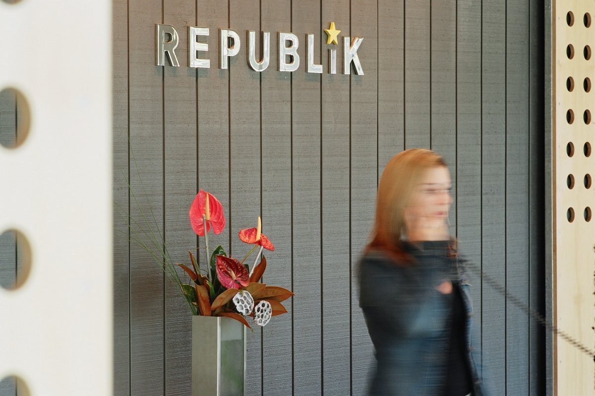 Office Layout Ideas: How to Plan a Better Workplace 3 Office reception at Republik in Auckland with brand lettering on a grey timber wall