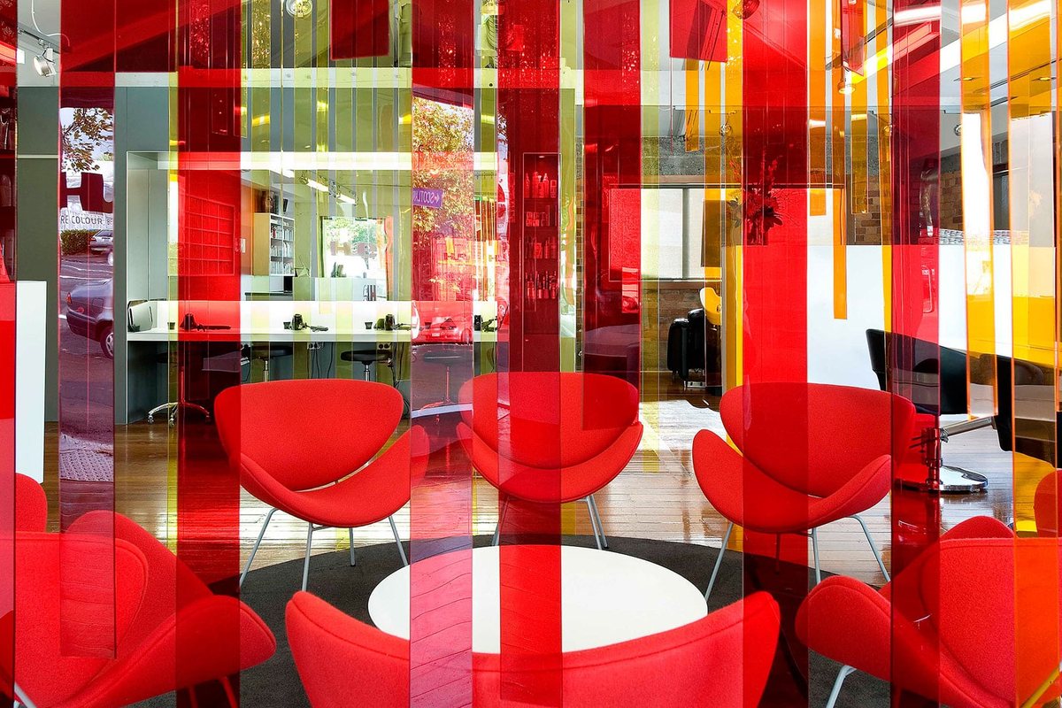 Salon Interior Design: Layout Ideas for Hair Salons 2 Red chairs inside a screen of coloured vertical strips in a hair colouring salon