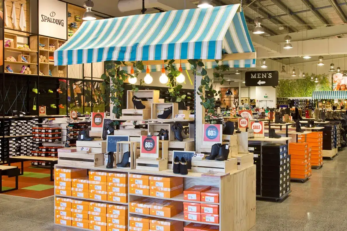 Visual Merchandising: Ideas From Real NZ Stores 2 Number One Shoes store with a market-stall style feature display under a striped awning, plywood units and boxed shoes